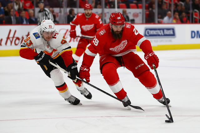 Wings roll over Flames in testy win